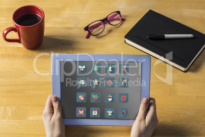 Composite image of businesswoman using tablet at desk