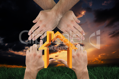 Composite image of hands making house shape