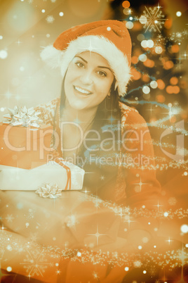 Composite image of festive brunette smiling at camera