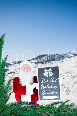 Composite image of santa claus showing blackboard