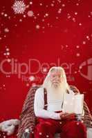Composite image of father christmas showing a book