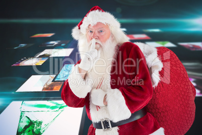 Composite image of santa asking for quiet with bag