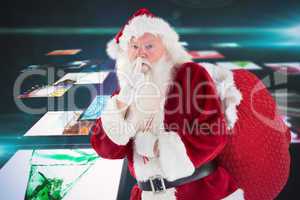 Composite image of santa asking for quiet with bag