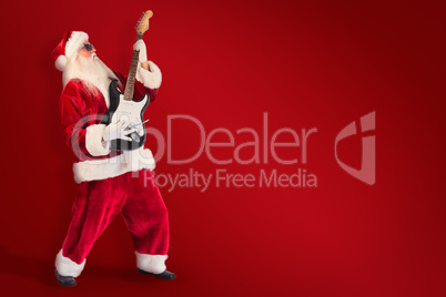 Composite image of santa playing electric guitar