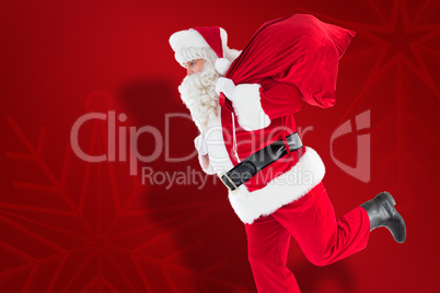 Composite image of santa claus walking with a sack