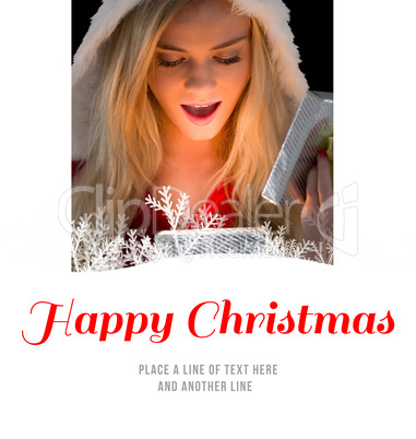 Composite image of pretty blonde in santa outfit opening gift