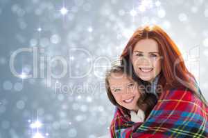 Composite image of mother and daughter under blanket