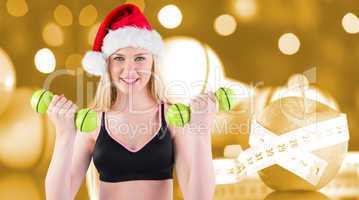 Composite image of festive fit blonde smiling at camera