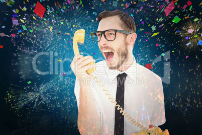 Composite image of geeky businessman shouting at telephone