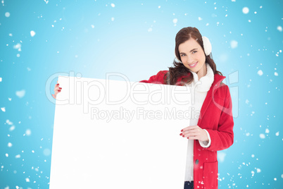 Composite image of happy brunette showing white poster