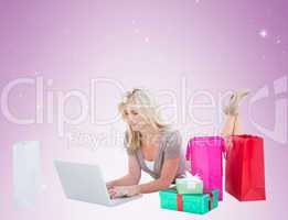 Happy blonde shopping online with laptop