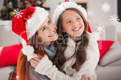 Composite image of festive mother and daughter on the couch with