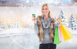 Composite image of blonde in winter clothes holding shopping bag