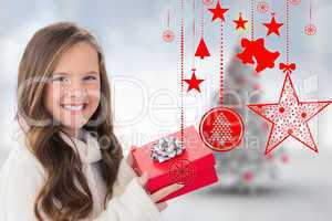 Composite image of girl holding gift