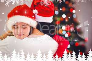 Composite image of mother and daughter hugging at christmas
