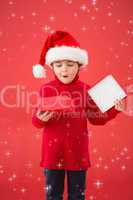 Composite image of festive little boy opening a gift