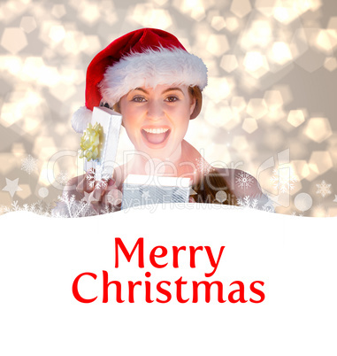 Composite image of sexy girl in santa costume opening a gift