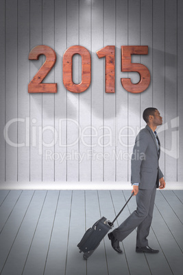 Composite image of young businessman pulling his suitcase Composite image of young businessman pulling his suitcase