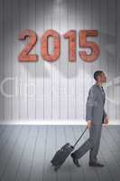 Composite image of young businessman pulling his suitcase