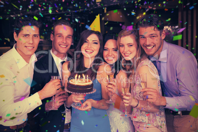 Composite image of attractive friends celebrating a birthday