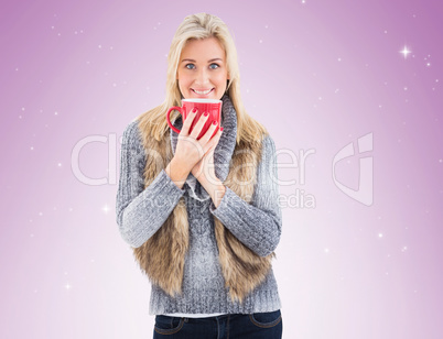 Woman in winter clothes holding a mug