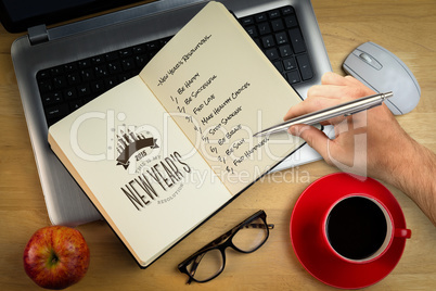 Composite image of hand holding a silver pen