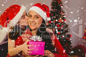 Composite image of daughter giving her mother a christmas presen