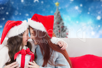 Composite image of mother and daughter with gift