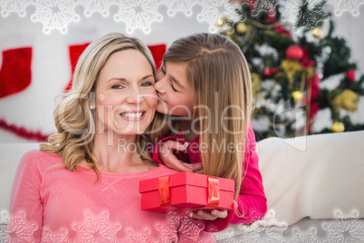 Composite image of little girl giving her mother a christmas gif