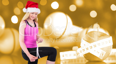 Composite image of fit festive young blonde measuring her thigh