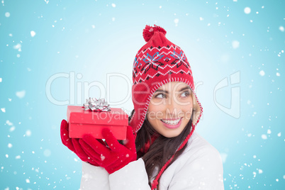 Composite image of happy brown hair holding red gift