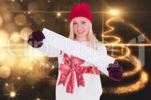 Composite image of festive blonde showing a blank banner