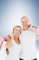 Composite image of couple with shopping bags