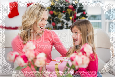 Composite image of little girl giving her mother a christmas gif