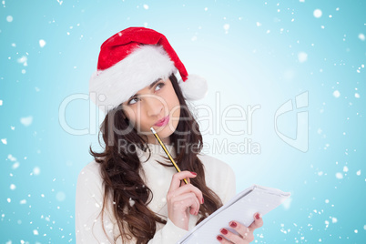 Composite image of festive brunette thinking about her christmas