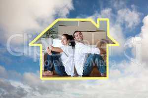 Composite image of bright couple with unpacking boxes moving to
