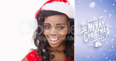 Composite image of woman wearing a santa claus hat