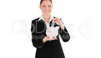 Composite image of charming woman in suit inserting a money bill