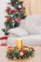 Composite image of candle and wreath on table for christmas