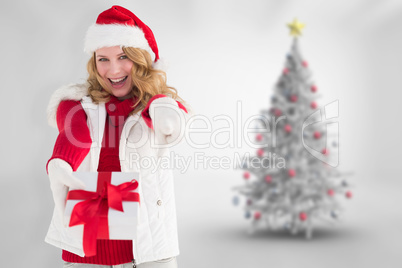 Composite image of festive blonde holding christmas gift and poi