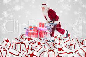 Composite image of santa delivering gifts from cart