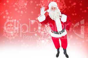 Composite image of santa holding a sack and waving