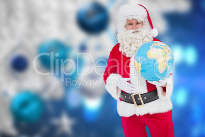 Composite image of happy santa claus holding a globe