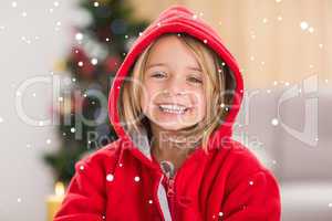 Composite image of festive little girl smiling at camera