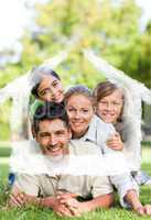 Composite image of happy family in the park