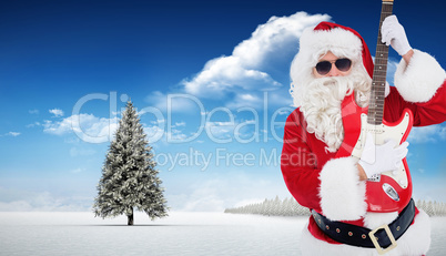 Composite image of santa with sunglasses playing electric guitar