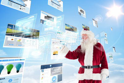 Composite image of santa shows something to camera