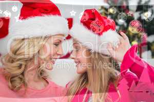 Composite image of festive mother and daughter smiling at each o