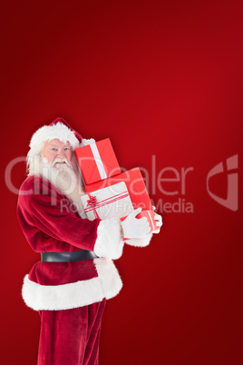 Composite image of santa carries a few presents