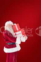 Composite image of santa carries a few presents